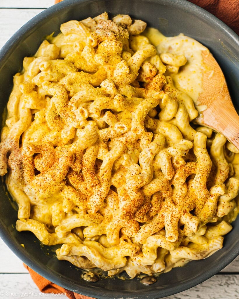 A pan of butternut squash mac and cheese with gluten free pasta and vegan cheese sauce. There is smoked paprika and nutritional yeast on top.