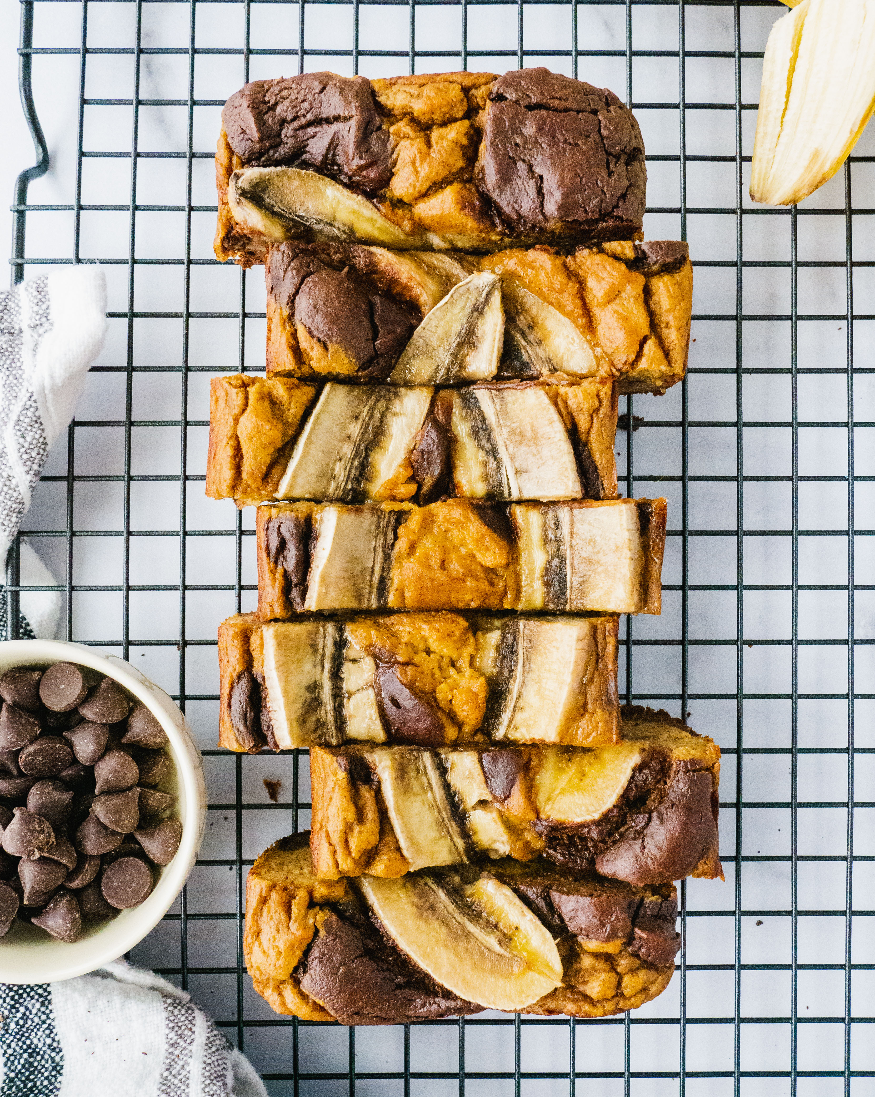 Paleo and gluten free brownie banana bread on a cooling rack with chocolate chip and baanana