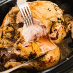 Crockpot chicken done cooking. I am pulling it apart with a fork and knife;
