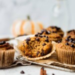 A table full of baked paleo breakfast treats. One has a bite taken from it