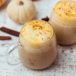 two healthy homemade pumpkin spice lattes with cinnamon on top. They are made with oat milk and espresso