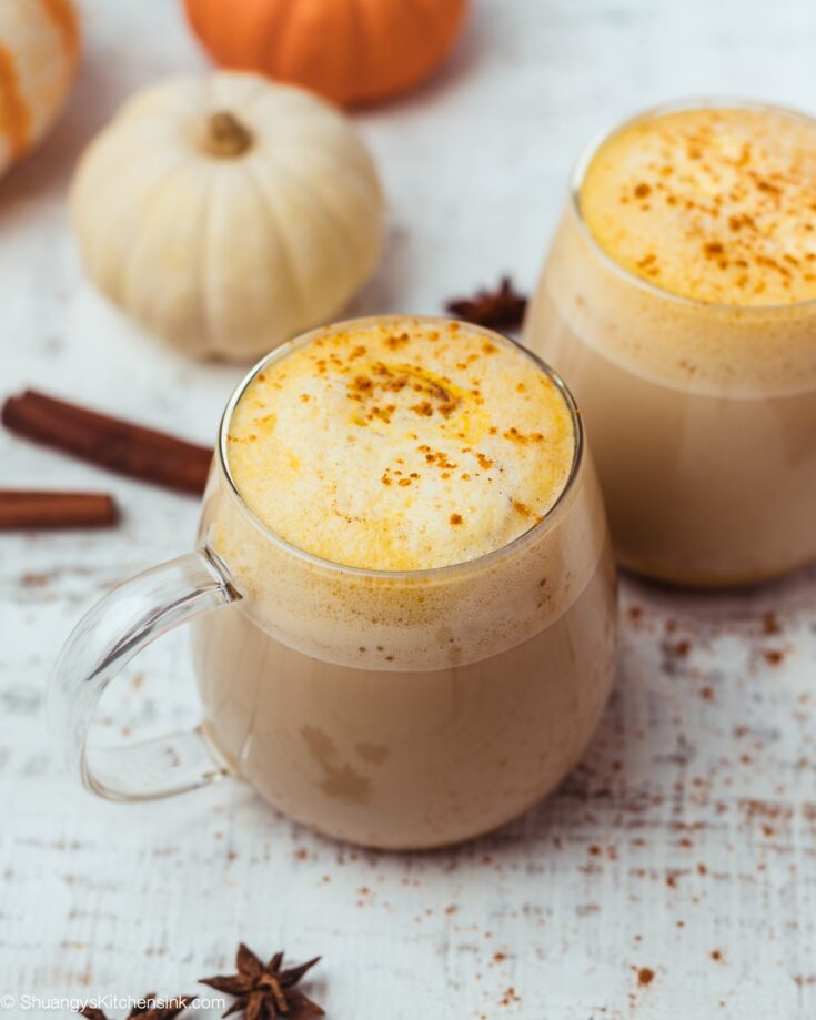 two healthy homemade pumpkin spice lattes with cinnamon on top. They are made with oat milk and espresso