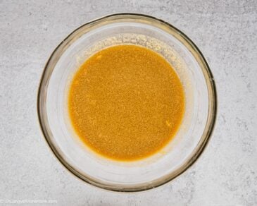 Pad thai sauce whisked together in a mixing glass bowl.