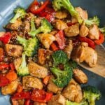 A pan of teriyaki chicken stir fry with broccoli and bell pepper.