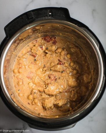 A pot of creamy peanut butter chicken before cooking in pressure cooker.