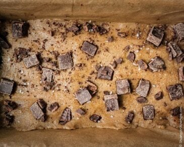 Peanut Butter Fudge with chocolate chips on top in a 9x5 loaf pan ready to go into the freezer.