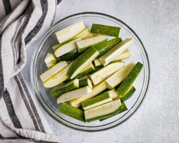 A bowl of zucchinis cut into strips.