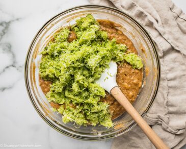 Step by step instruction on how to make zucchini banana bread in a bowl.