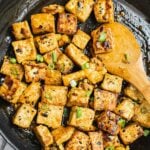 A pan of Asian Garlic Tofu stir fry freshly cooked and glazed with soy garlic sauce. Topped with scallion.