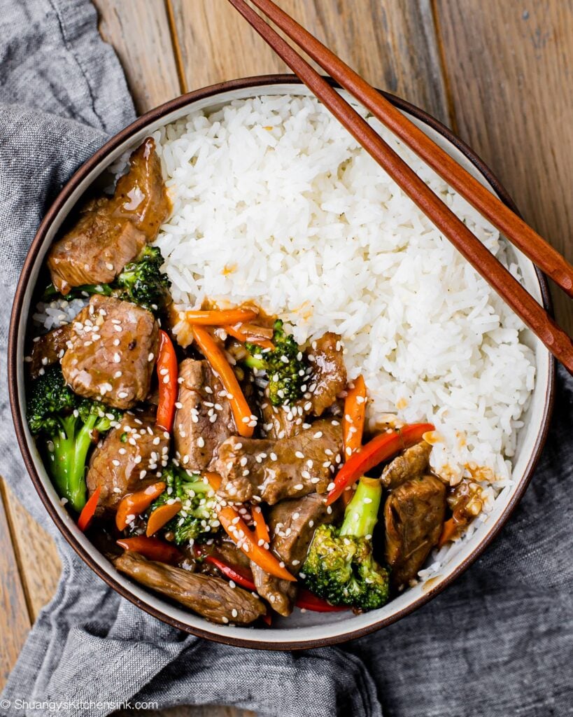 Beef and Broccoli in serving bowl with rice, Chop sticks