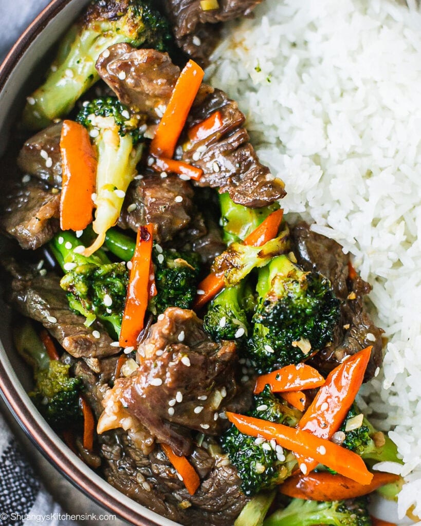 A bowl of healthy beef and broccoli stir fry served with jasmine rice.