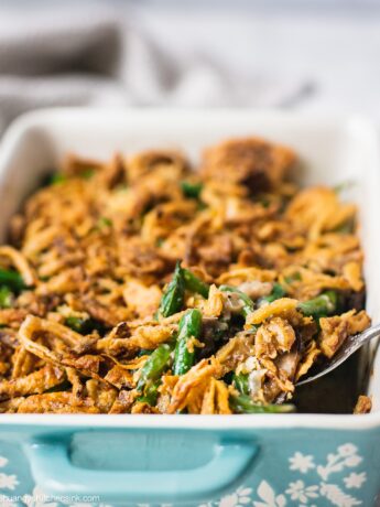 A pan of freshly baked healthy green bean casserole topped with golden brown gluten free crispy onion.