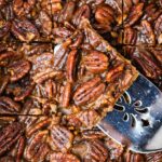 squares of nutty holiday dessert in a salted caramel sauce