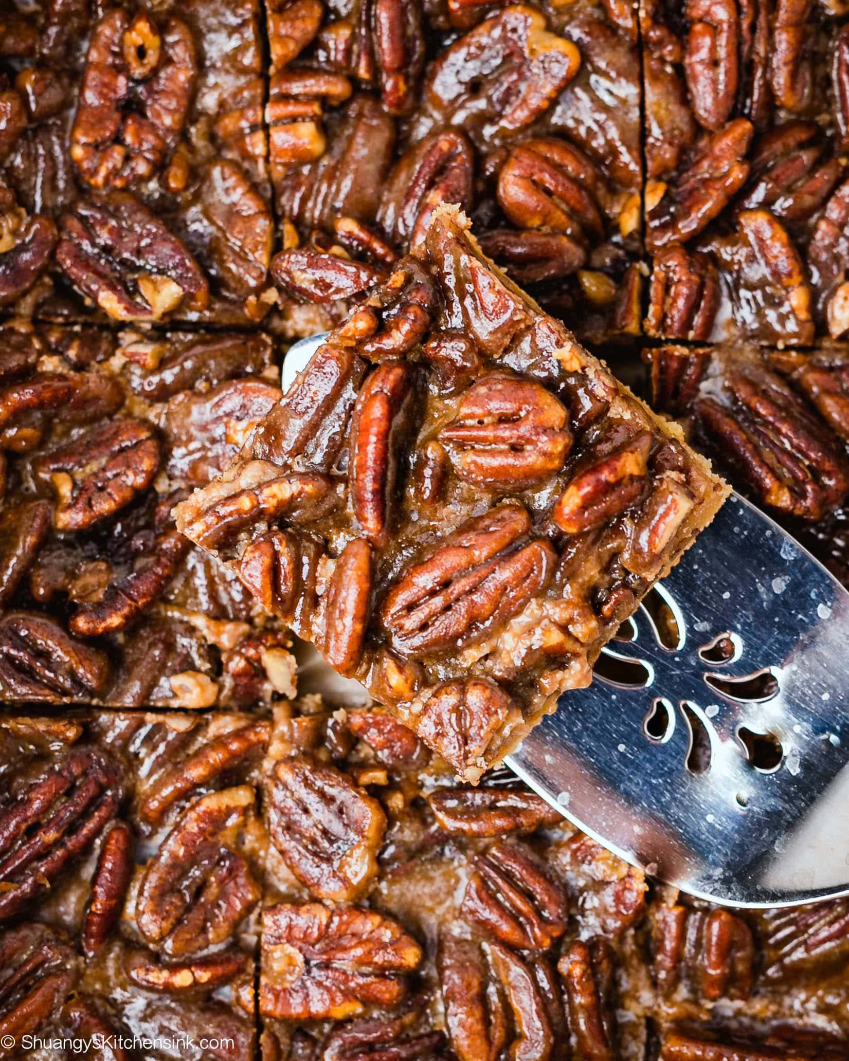 squares of nutty holiday dessert in a salted caramel sauce