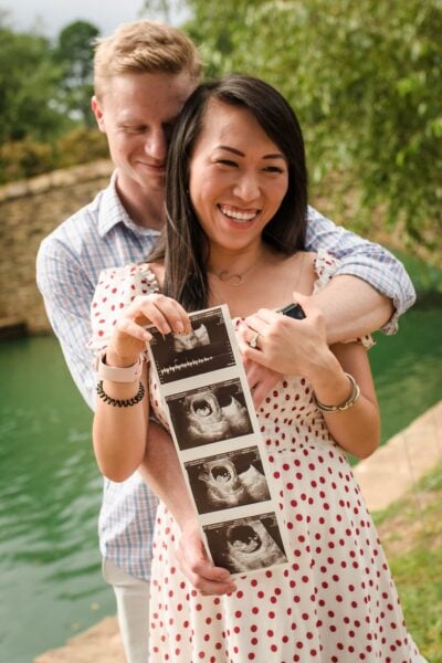 Food blogger Shuangy and her husband Tom are having their first baby announcement. They are holding a few of their baby's ultrasound photos.