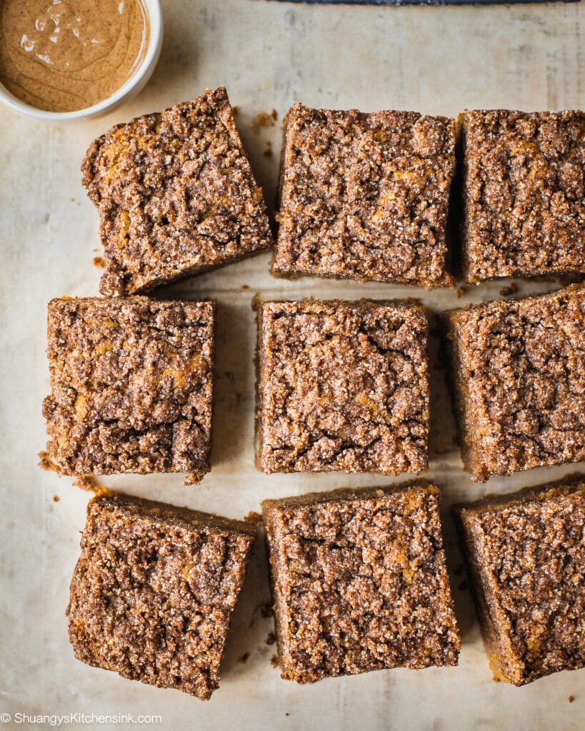 A batch of freshly baked paleo coffee cake topped with cinnamon crumble toppings and almond butter.