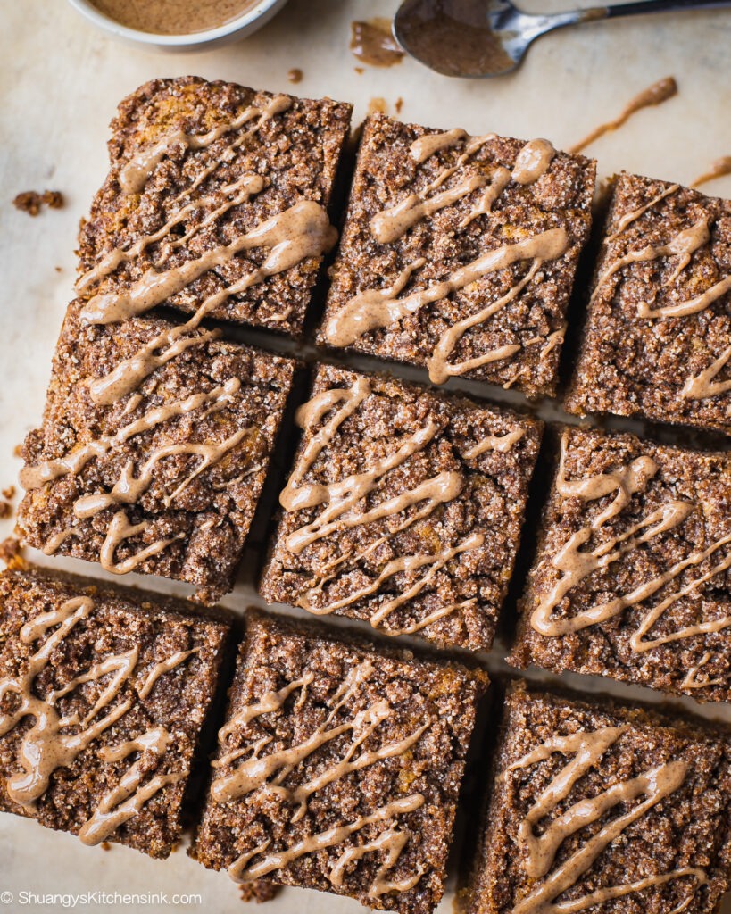 A batch of freshly baked paleo coffee cake topped with cinnamon crumble toppings and almond butter.