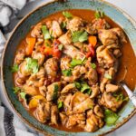 A plate of keto butter chicken that is cooked in flavorful Indian Spiced sauce in the instant pot. It has cilantro on top for garnish.