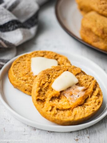 A gluten free vegan biscuit is cut in half. This gluten free buttermilk biscuit is served with vegan butter.