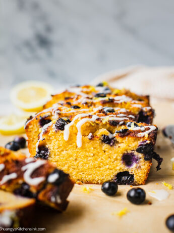 A loaf of sliced keto blueberry lemon bread with coconut butter.