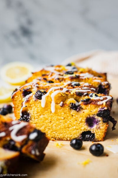 A loaf of sliced keto blueberry lemon bread with coconut butter.