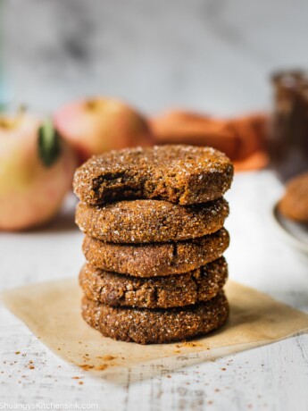 Soft and chewy apple butter cookies stacked on top of each other. There are five cookies and one has a bite taken from it