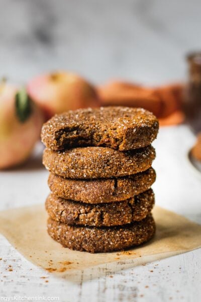 Soft and chewy apple butter cookies stacked on top of each other. There are five cookies and one has a bite taken from it