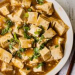 A bowl of Authentic Chinese Sticky tofu in a fragrant vegan stir-fry sauce