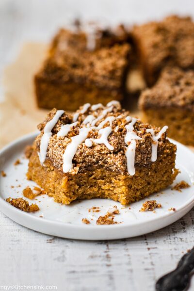A piece of gluten-free cake with a paleo topping is drizzles with maple icing