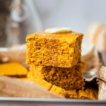 moist and fluffy gluten-free pumpkin cornbread topped with vegan butter