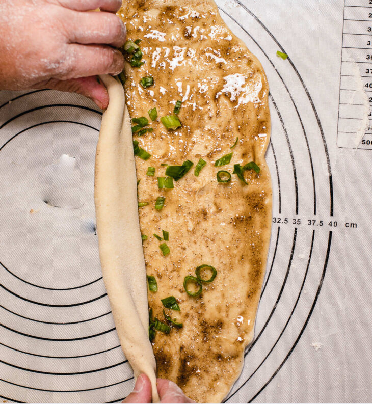 Starting from the long side, tightly roll the dough into a long cylinder.