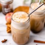two homemade vegan Starbucks copycat apple crisp macchiato drinks on a fall decorated table