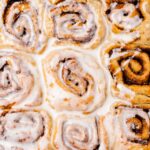 A baking dish with fluffy baked dessert topped with vegan icing