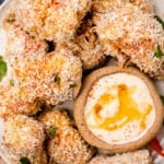 A plate of Salmon nuggets with parsley garnish, and a bowl of chipotle honey dipping sauce
