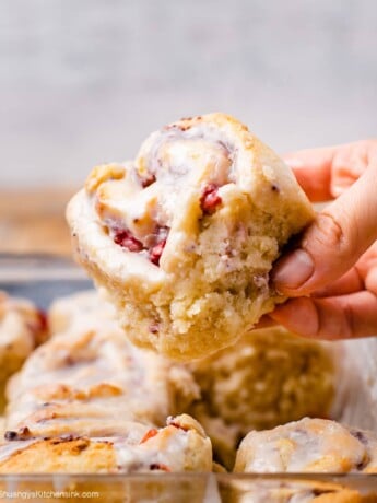 A hand is holding a soft and delicious strawberry roll