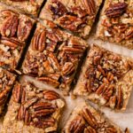 There are chai spiced oat bars sitting on parchment paper spread out