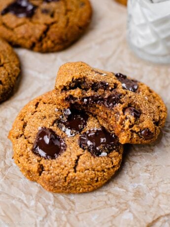 image shows the pumpkin chocolate chip cookie stacked on top of each other with a bite taken