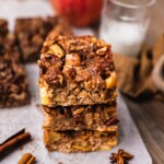Apple Butter Baked Oatmeal is perfectly baked and stacked on top of each other on parchment paper