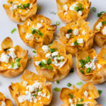 crispy wonton appetizers garnished with blue cheese crumbles