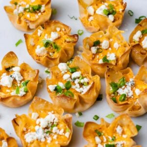 crispy wonton appetizers garnished with blue cheese crumbles