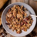 A spoon is being used in the bowl of pumpkin granola