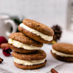 Gingerbread cookie sandwiches are stacked on top of each other