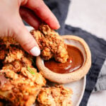 chicken nuggets are being served on a plate with an asian dipping sauce