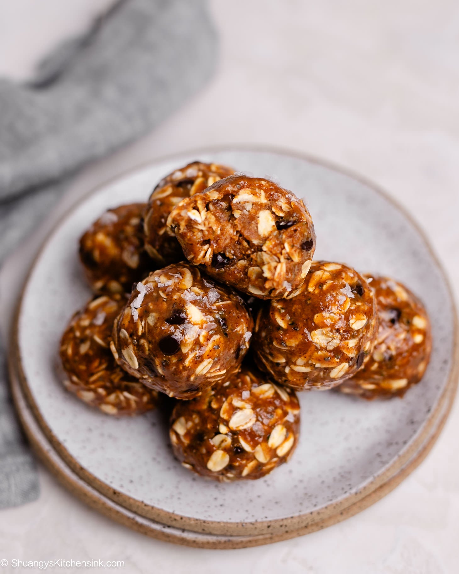 A plate of almond butter protein balls made with rolled oats.