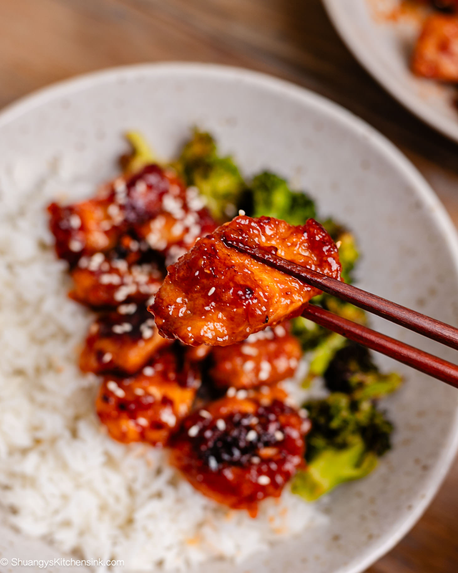 Crispy golden-brown sweet and sour pork strips coated in sticky honey-ketchup sauce, served with pineapple and bell peppers.