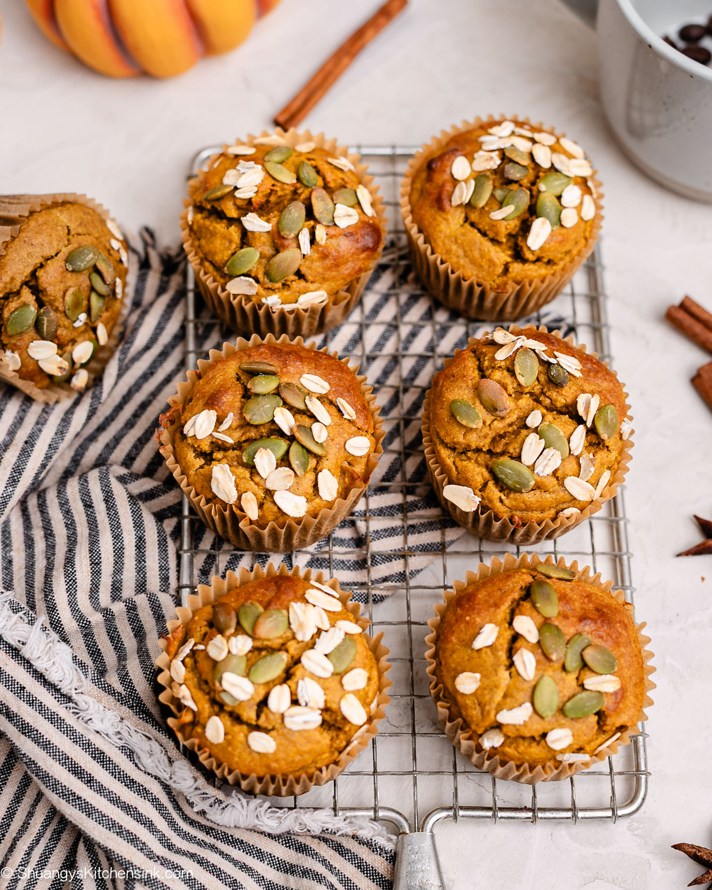 Overhead shot of pumpkin oat muffins cooling on a wire rack