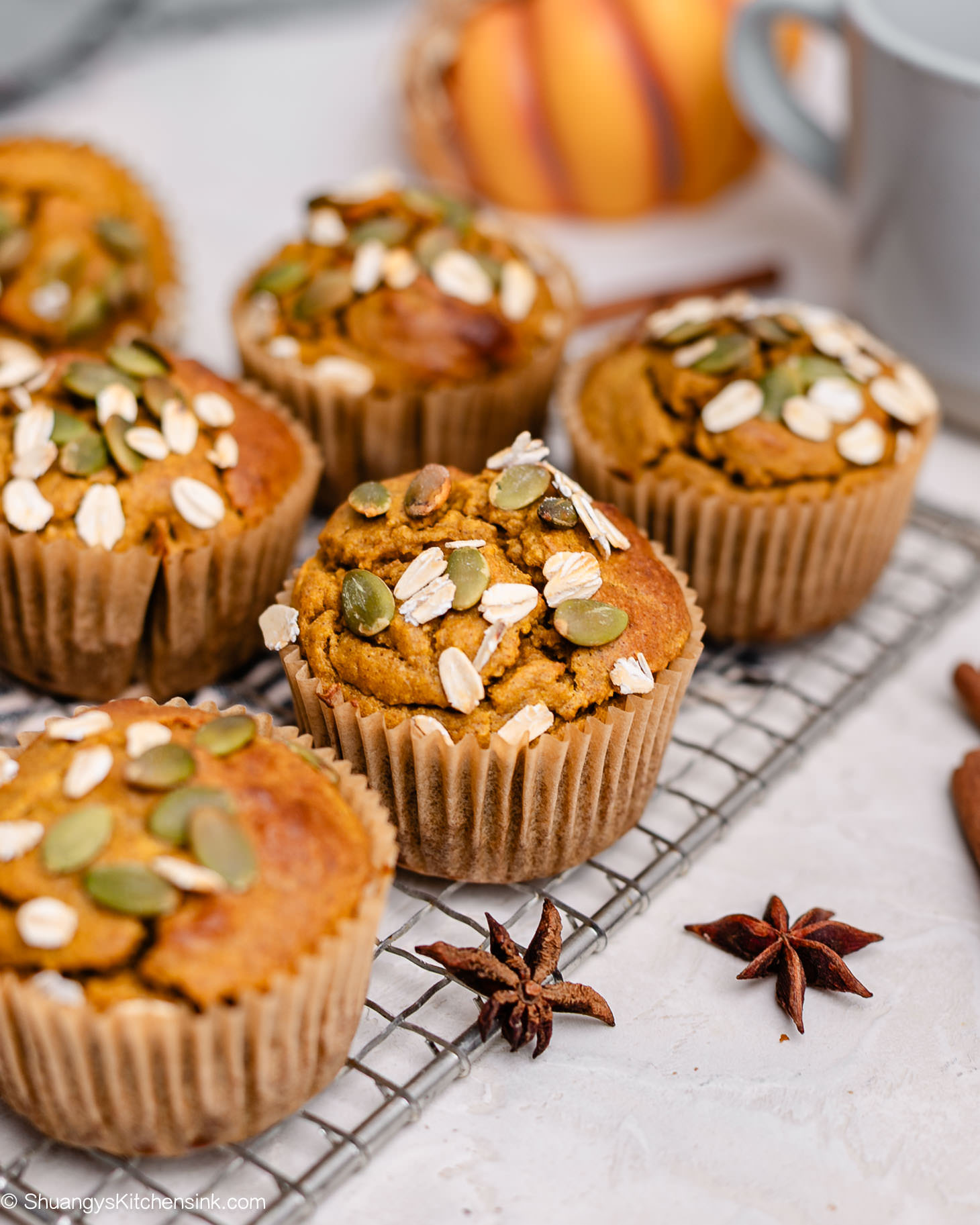 Overhead shot of pumpkin oat muffins cooling on a wire rack