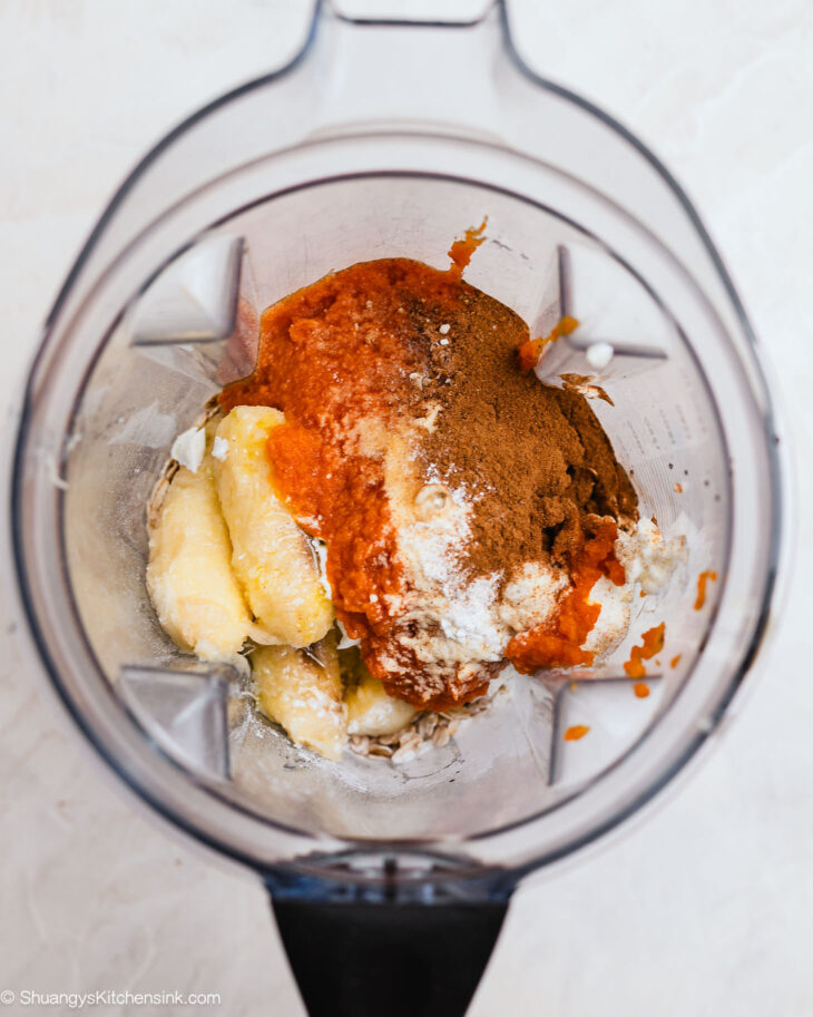 Blender filled with pumpkin muffin batter made with oats and bananas