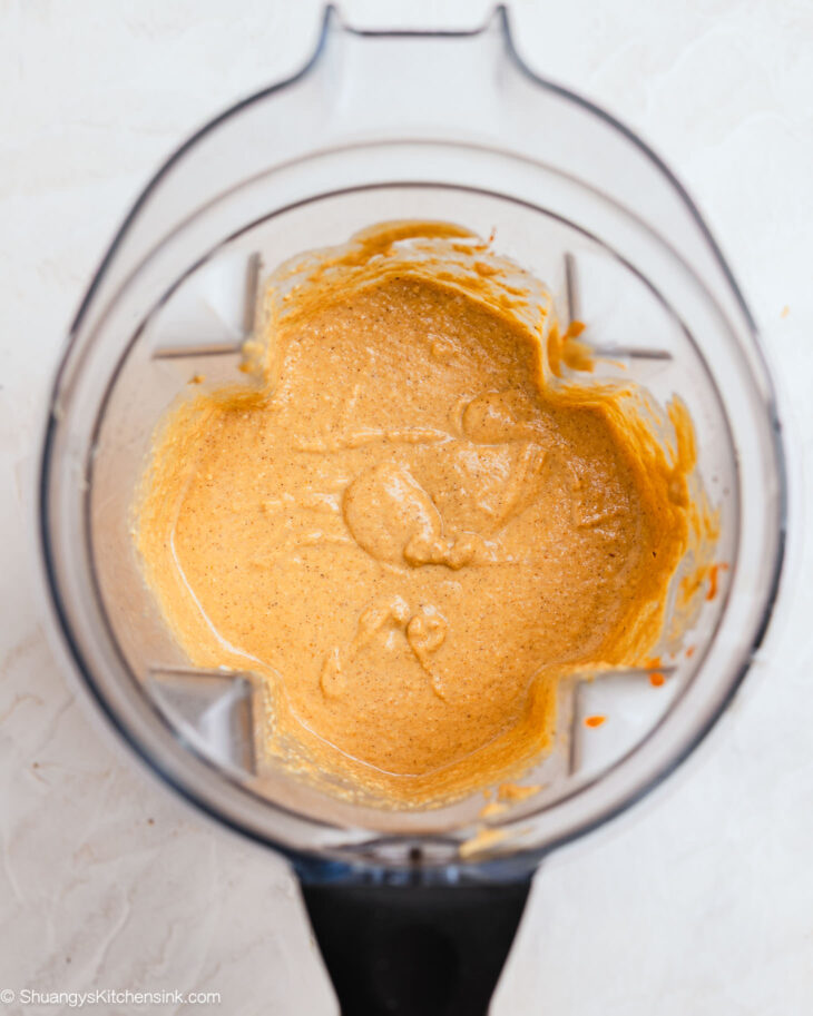 Blender filled with pumpkin muffin batter made with oats and bananas