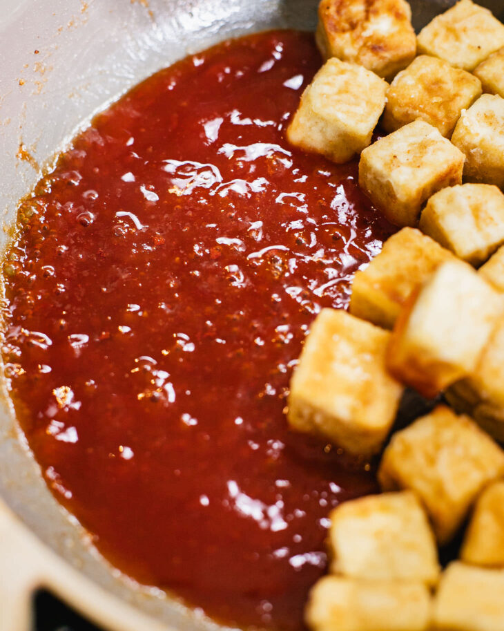 Instruction on how to make sweet and sour tofu - Heat the sauce on low until it starts to bubble.